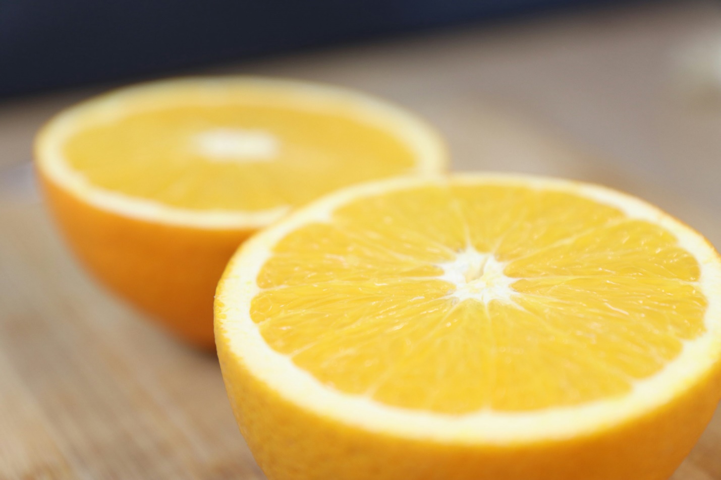 two halves of an orange sitting on a table